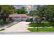 Charming single story home featuring a red tile roof, white exterior and two-car garage at 11334 Winwood Pl # 11334, Port Richey, FL 34668