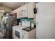 Bright, fully-equipped kitchen with modern appliances and wooden style floors leading into the dining area at 11334 Winwood Pl # 11334, Port Richey, FL 34668