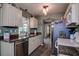 Well-lit kitchen featuring white cabinetry, stainless steel appliances, and hardwood-style flooring at 11334 Winwood Pl # 11334, Port Richey, FL 34668