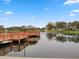 Scenic lake view featuring a wooden gazebo, fountain, and waterfront homes on a sunny day at 11334 Winwood Pl # 11334, Port Richey, FL 34668