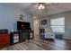 Comfortable living room with a large television and decorative fireplace, with natural light and ceiling fan at 11334 Winwood Pl # 11334, Port Richey, FL 34668