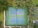 Aerial shot of well-maintained tennis courts with lush greenery and parking nearby at 11334 Winwood Pl # 11334, Port Richey, FL 34668