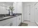 Bright bathroom features a double vanity with granite countertop and a tiled shower with glass doors at 11693 Lavender Loop, Spring Hill, FL 34609