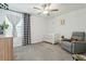 Cozy Bedroom with a crib, gray glider, black and white curtains, and plush carpeting at 11693 Lavender Loop, Spring Hill, FL 34609