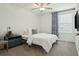 Comfortable bedroom featuring soft carpeting, a ceiling fan, and a neatly made bed with decorative pillows at 11693 Lavender Loop, Spring Hill, FL 34609