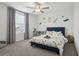 Charming bedroom features a dinosaur-themed decor, a plush bed, and a ceiling fan for comfort at 11693 Lavender Loop, Spring Hill, FL 34609