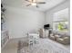 Versatile bonus room featuring a computer desk, comfortable seating, and a calming atmosphere for various activities at 11693 Lavender Loop, Spring Hill, FL 34609