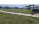 Wide green space with walking path, trees, and seating in a neighborhood park at 11693 Lavender Loop, Spring Hill, FL 34609