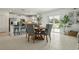 Open-concept dining area with a view to the backyard and kitchen, complemented by a round wooden table at 11693 Lavender Loop, Spring Hill, FL 34609