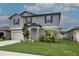 Attractive exterior view of a two-story home with a well-maintained lawn and an attached two-car garage at 11693 Lavender Loop, Spring Hill, FL 34609
