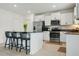 Modern kitchen with stainless steel appliances, a breakfast bar with seating, and bright white cabinetry at 11693 Lavender Loop, Spring Hill, FL 34609