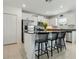 Well-lit kitchen featuring a central island with seating, stainless steel appliances, and elegant granite countertops at 11693 Lavender Loop, Spring Hill, FL 34609