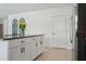 Stylish kitchen island featuring dark granite countertop, white cabinetry, and stainless steel refrigerator at 11693 Lavender Loop, Spring Hill, FL 34609