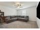 Spacious living room with plush carpeting, a ceiling fan, and a comfortable sectional sofa at 11693 Lavender Loop, Spring Hill, FL 34609