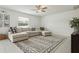 Spacious living area with sectional sofa, ceiling fan, and decorative rug, perfect for Gathering gatherings at 11693 Lavender Loop, Spring Hill, FL 34609