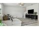 Inviting living room featuring a comfortable sectional sofa, ceiling fan, and entertainment area for relaxation at 11693 Lavender Loop, Spring Hill, FL 34609