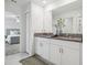 Elegant main bathroom with double sink vanity, granite countertop, and modern fixtures for a luxurious experience at 11693 Lavender Loop, Spring Hill, FL 34609