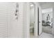 Modern shower with white subway tile, open doorway and high-end fixtures, creating a spa-like ambiance at 11693 Lavender Loop, Spring Hill, FL 34609