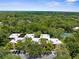 Aerial view of condo buildings nestled within a lush, green landscape at 11805 Raintree Lake Ln # A, Tampa, FL 33617