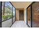 Cozy screened balcony with tile flooring, offers a private space for relaxing outdoors at 11805 Raintree Lake Ln # A, Tampa, FL 33617