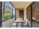 Relaxing screened-in balcony with stylish seating, perfect for enjoying peaceful outdoor moments at 11805 Raintree Lake Ln # A, Tampa, FL 33617