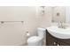 This half-bath features a ceramic sink and toilet, and a towel rack at 11805 Raintree Lake Ln # A, Tampa, FL 33617