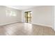 Large bedroom featuring a window to the left and glass sliding door leading to the patio at 11805 Raintree Lake Ln # A, Tampa, FL 33617