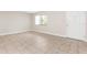 Spacious, tiled room with natural light from a window, and featuring a white entry door at 11805 Raintree Lake Ln # A, Tampa, FL 33617