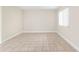 Neutral bedroom with tile flooring, large window, and ample space for customization at 11805 Raintree Lake Ln # A, Tampa, FL 33617