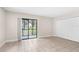 Well-lit bedroom with tiled floor, glass sliding doors, and closet at 11805 Raintree Lake Ln # A, Tampa, FL 33617