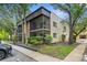 Inviting condo exterior featuring a screened balcony surrounded by lush landscaping and mature trees at 11805 Raintree Lake Ln # A, Tampa, FL 33617