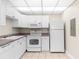 Bright kitchen with white appliances, tile floors and plenty of cabinet space at 11805 Raintree Lake Ln # A, Tampa, FL 33617