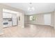 Spacious living area with tile flooring open to the bright kitchen with white appliances at 11805 Raintree Lake Ln # A, Tampa, FL 33617