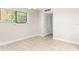 Neutral living room with tile floors, bright window, and neutral color scheme at 11805 Raintree Lake Ln # A, Tampa, FL 33617
