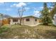 Backyard with a lawn area, trees, and a wooden fence, offering a serene outdoor space at 1305 Marion S Dr, St Petersburg, FL 33707