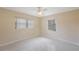 Empty bedroom with a ceiling fan and two windows with natural light at 1305 Marion S Dr, St Petersburg, FL 33707