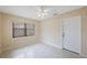 Inviting bedroom with neutral walls, natural light from the window, and terrazzo floors at 1305 Marion S Dr, St Petersburg, FL 33707