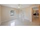 Comfortable bedroom featuring ample sunlight and a closet with mirrored doors, leading to hallway at 1305 Marion S Dr, St Petersburg, FL 33707