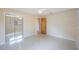Bright bedroom features a large closet with mirrored doors, ceiling fan, and hardwood door at 1305 Marion S Dr, St Petersburg, FL 33707