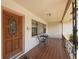 Inviting front porch with tile flooring, space for seating, and a classic wooden front door at 1305 Marion S Dr, St Petersburg, FL 33707