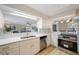 Modern kitchen with white cabinets, subway tile backsplash, stainless steel appliances, and an open layout at 1305 Marion S Dr, St Petersburg, FL 33707