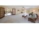 Spacious living room with neutral carpet, a ceiling fan, and a glass door leading to a patio at 1305 Marion S Dr, St Petersburg, FL 33707