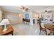 Inviting living room featuring terrazzo flooring, ceiling fans, and seamless flow to the dining area at 1305 Marion S Dr, St Petersburg, FL 33707