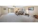 Bright living room features carpeted floors, ceiling fan, neutral walls and comfortable seating area with sliding glass door at 1305 Marion S Dr, St Petersburg, FL 33707