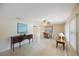 Open-concept living room with dining area, speckled floors, neutral walls, and modern ceiling fan at 1305 Marion S Dr, St Petersburg, FL 33707