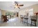 Open-concept living space with dining area, breakfast bar, and stylish terrazzo floors, creating an inviting and modern ambiance at 1305 Marion S Dr, St Petersburg, FL 33707