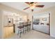 Open-concept living space with a kitchen view, breakfast bar, and stylish terrazzo floors for a modern ambiance at 1305 Marion S Dr, St Petersburg, FL 33707