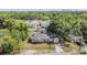 Aerial view of a brick house amidst lush greenery in a suburban area at 1511 East Emma St. E St, Tampa, FL 33610