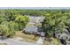 Bird's eye view of a traditional brick home with lush tree surround, offering a serene and private atmosphere at 1511 East Emma St. E St, Tampa, FL 33610