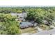 Aerial view of a brick home surrounded by lush greenery and other buildings in the neighborhood at 1511 East Emma St. E St, Tampa, FL 33610